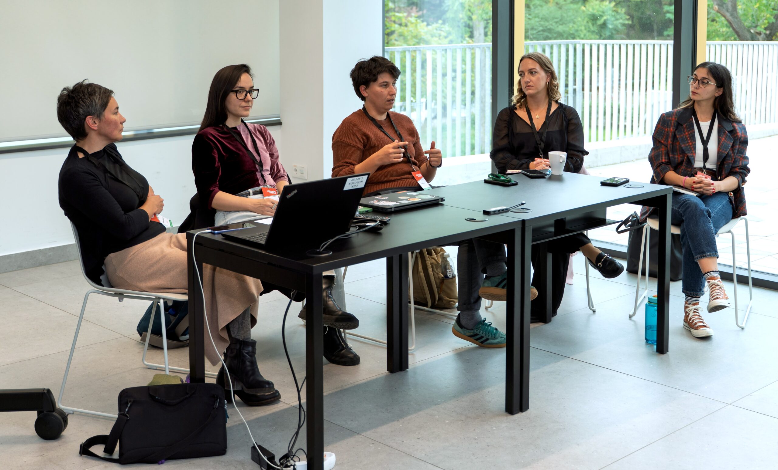 Five women sitting on a panel.