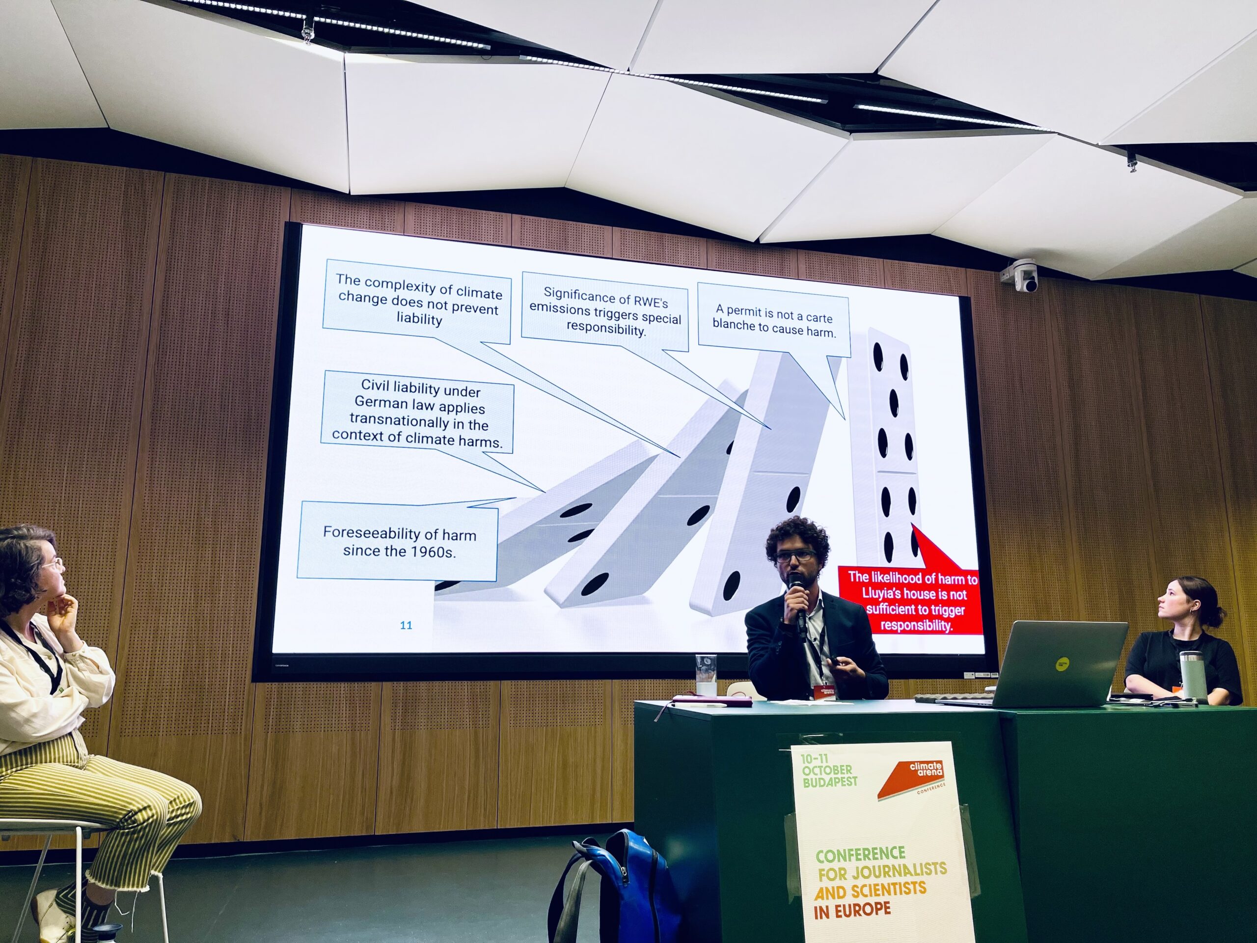 Sébastien Duyck presents a powerpoint slide that shows the 'domino effect' of certain arguments necessary to achieve certain burdens of proof in climate litigation cases. Here we see dominos falling one after another with labels: " foreseeability of harm since the 1960s", "civil liability under German law applies transnationally in the context of climate harms", "the complexity of climate change does not prevent liability", significance of RWE's emissions triggers special responsibility", "a permit is not a carte blanche to cause harm" and then a final label in red (designating that it was the final part of the argument not proven, ultimately resulting in the loss of the case) "the likelihood of harm to Lluyia's house is not sufficient to trigger responsibility."